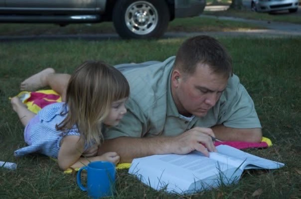 A young Dr. Hardy studying with his daughter Grace