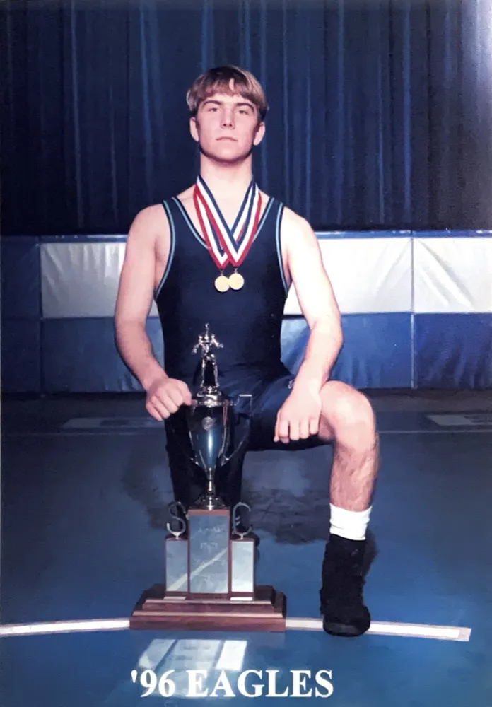 Dr. Hardy as a Chapin wrestler with trophy and medals